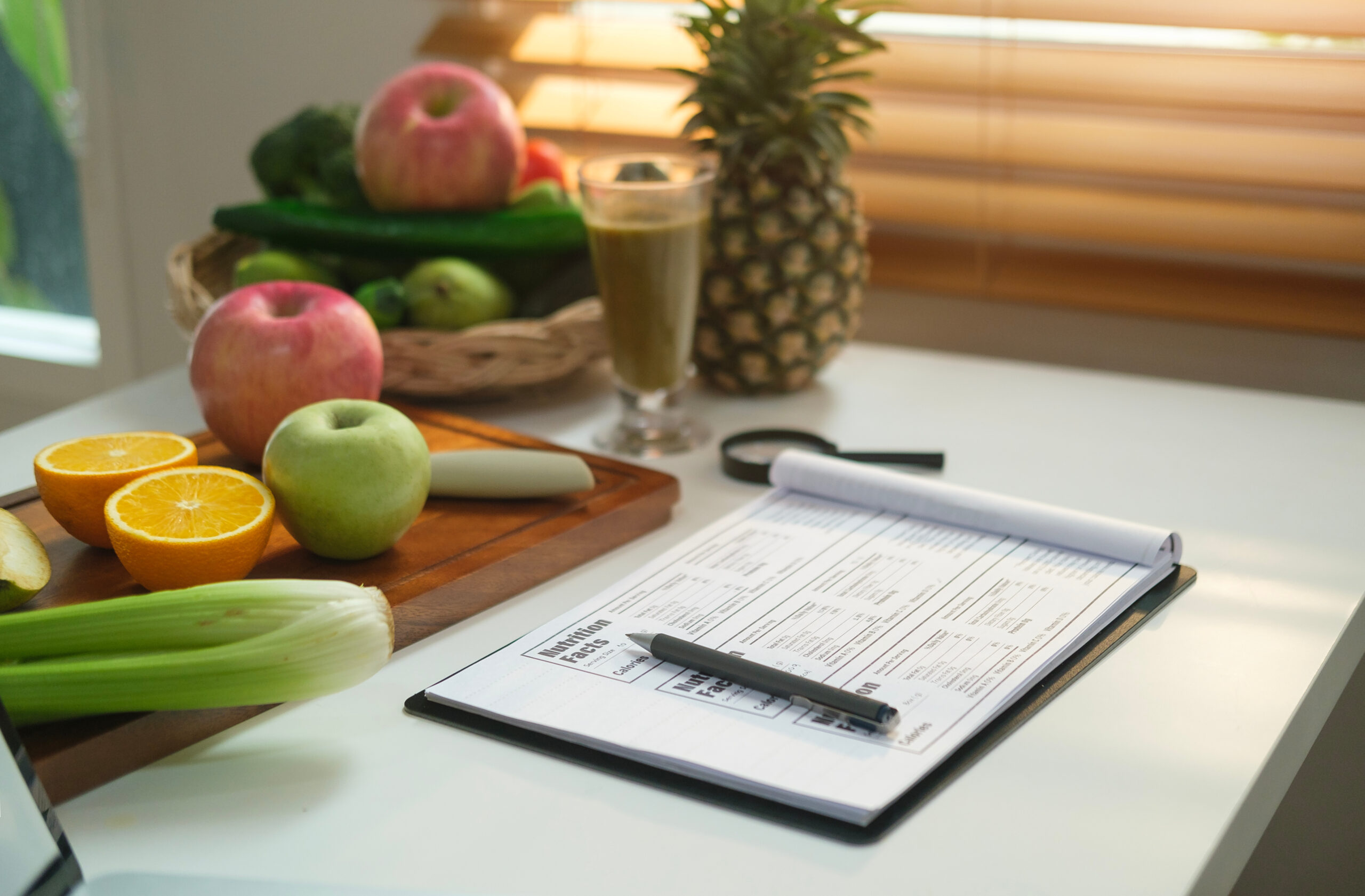 Sheet of diet plan and different healthy food ingredients on whi